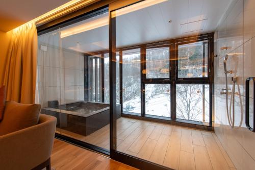a living room with a large window and a couch at Niseko Kyo in Kutchan