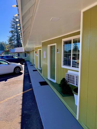 a yellow building with a car parked in front of it at Chalet Motel - Affordable Stay in Central Bend in Bend