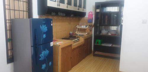 a kitchen with a blue refrigerator in a room at Villa GeGe Puncak in Cipayung