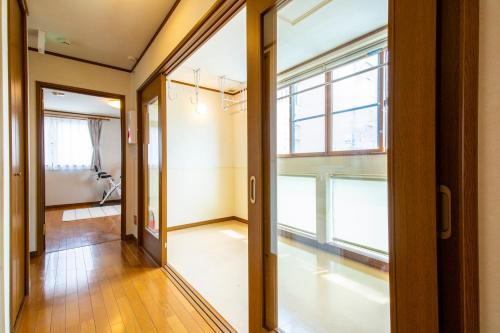 an empty hallway with a large window in a building at No1 Private Hotel&Villa Aomoril 186平米貸切 最大12名 in Aomori