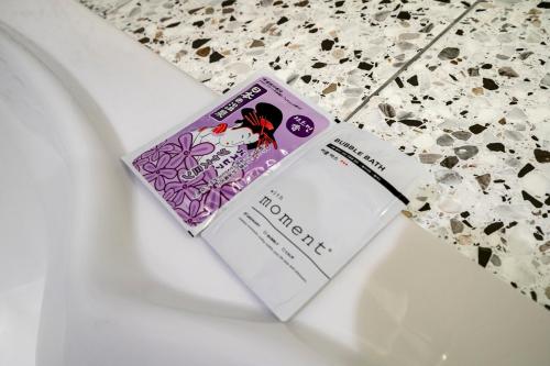 a book sitting on top of a toilet at 충주 어반브라운호텔 in Chungju