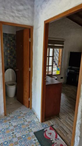 an open door to a bathroom with a toilet at Birdsong lodge in Mocoa