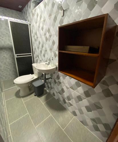a bathroom with a toilet and a sink at Casa turistica JB in Líbano