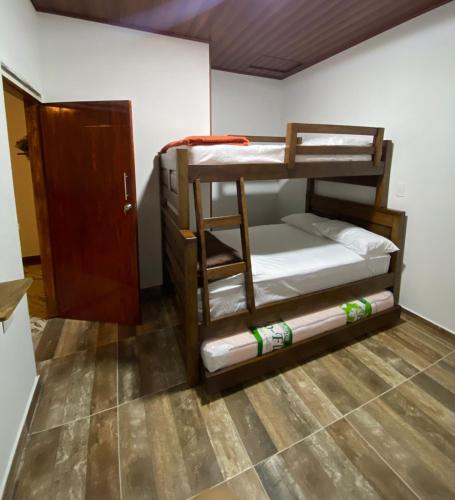 a room with two bunk beds and a door at Casa turistica JB in Líbano