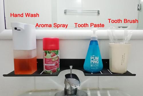 a shelf above a kitchen sink with some items on it at Hongik Univ Hongdae Stay in Seoul