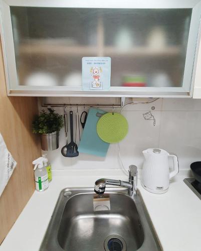a kitchen counter with a sink and a window at Hongik Univ Hongdae Stay in Seoul