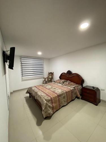 a bedroom with a bed and a television in it at Espectacular casa en Manizales in Manizales