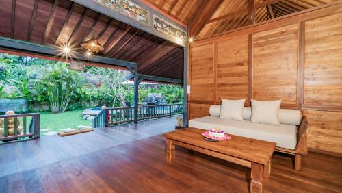 a bedroom in a villa with a bed and a table at The Puspa Villa in Sukawati