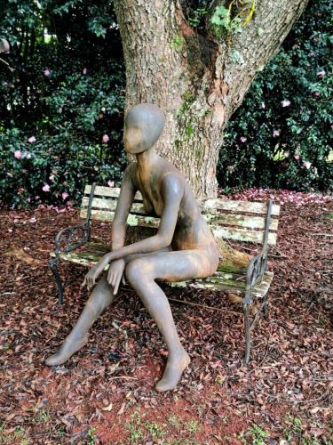 a bronze statue of a woman sitting on a bench at Wyndover Mountain Retreat in Beechmont