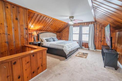 a bedroom with a bed in a room with wooden walls at King Bed Private Home in Dearborn