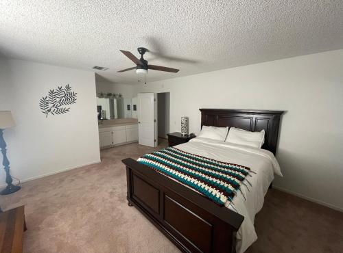 a bedroom with a bed and a ceiling fan at Quaint Vintage Ranch Style 4BedRoom 2Bath Sleeps 10 in Lancaster