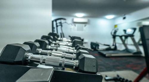 a gym with rows of exercise equipment in a room at Azure Sea Whitsunday Resort in Airlie Beach