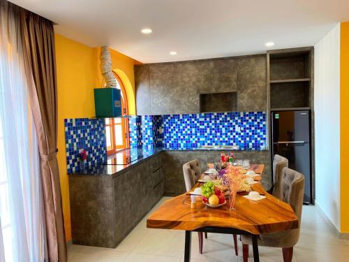 a dining room with a wooden table and chairs at AT Hotel & Cafe in Phu Quoc