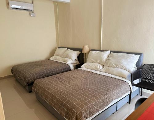 a room with two beds in a room at Nibong Tebal Studio Home Stay in Nibung Tebal