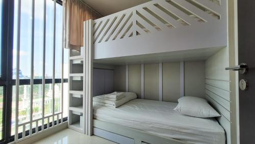 a white bunk bed in a room with a window at Palam Mansion at Apartment One Residence in Batam Center
