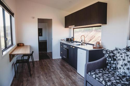 a small kitchen with a sink and a counter at High Valley Dawn Permaculture Farm in Yeppoon