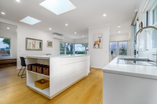 キャンベラにあるSerene 3BR Haven in Ainslie - Ideal Getaway - Hosted by Canstayのキッチン(白いカウンター、シンク付)