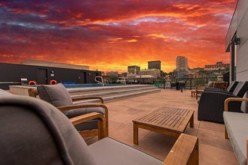 a rooftop deck with chairs and a sunset at City Center, 2 bathroom, AC, Parking, Pool in Quebec City