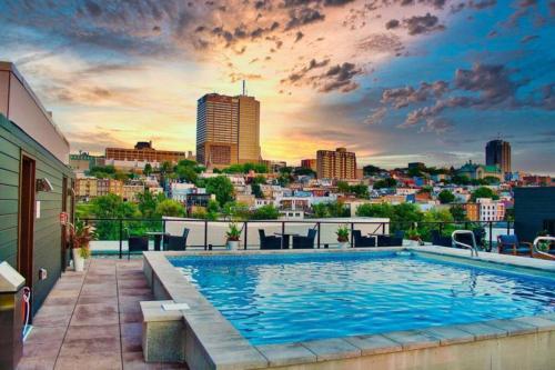 a swimming pool on top of a building with a city skyline at City Center, 2 bathroom, AC, Parking, Pool in Quebec City