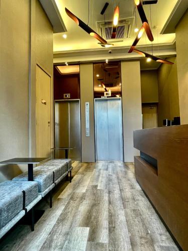 a waiting room with benches and a table in a building at 木居 Woody House in Hong Kong