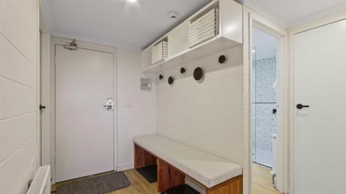 a room with a bench and a door at Alpine Heights 9 in Mount Hotham