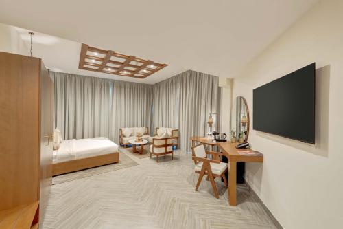 a hotel room with a bed and a desk at Western Hotel Liwa in Liwa