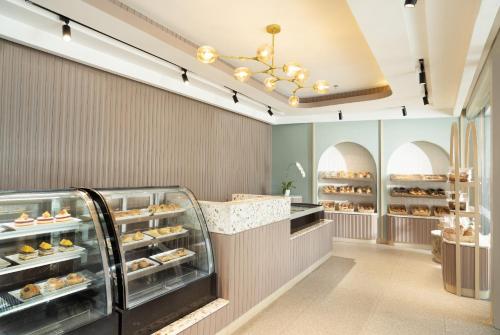 a bakery with a display case filled with pastries at Hotel Santika Premiere Lampung in Bandar Lampung
