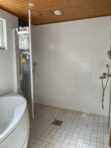 a bathroom with a toilet and a tile floor at Peaceful Residence Helsinki Laajasalo in Helsinki