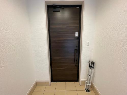 a hallway with a wooden door in a room at GENYA Furano in Nakafurano