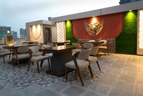 a restaurant with tables and chairs on a patio at Revaa Hotels in kolkata