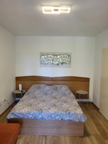 a bedroom with a bed with a blue comforter at Margaret 150 METERS TO THE BEACH in Banjole