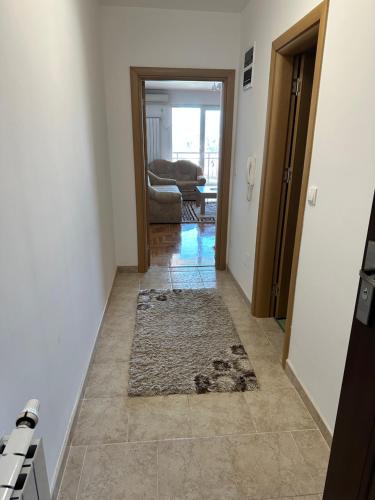 a hallway with a door and a rug on the floor at Air Urban in Sarajevo