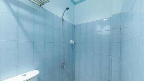 a bathroom with a shower and a toilet at RedDoorz @ Raj Inn Guimaras in Oracon