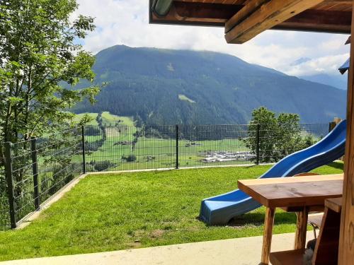 a playground with a slide and a view of a mountain at Apartment Mayerhofer in Mittersill
