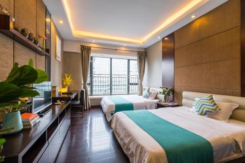 a hotel room with two beds and a window at Livetour Hotel Kehui Golden Valley Guanzhou in Guangzhou