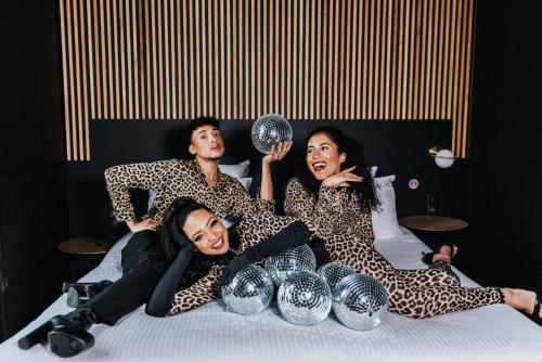 a group of three people laying on a bed at La Folie Douce Hotels Chamonix in Chamonix-Mont-Blanc