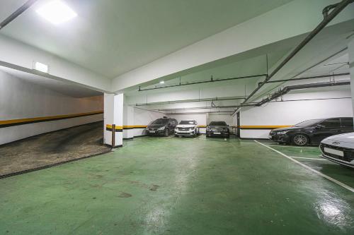 a parking garage with several cars parked in it at Grazie Hotel Tanhyeon in Goyang