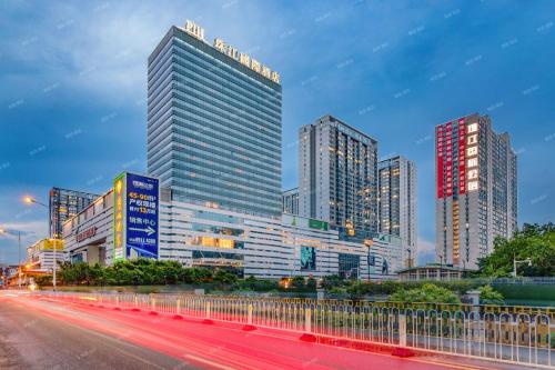 a city skyline with tall buildings and a street at Pearl River International Hotel - Canmetro line 11 YiJing Lu station in Guangzhou
