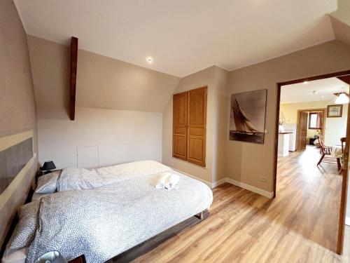a bedroom with a dog laying on a bed at La longère T3 - Au Golf de Bellême - Parking - Wifi - 4 Pers in Bellême