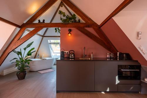 a bathroom with a sink and a bath tub in a roof at The Swiete Den Haag - 2 Stylish boutique apartments - Between city center and the beach in The Hague