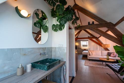 a bathroom with a green sink and a living room at The Swiete Den Haag - 2 Stylish boutique apartments - Between city center and the beach in The Hague