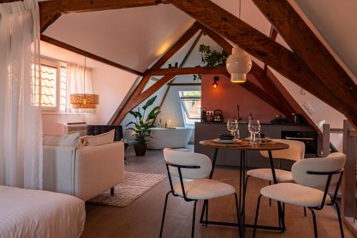 a room with a bed and a table and chairs at The Swiete Den Haag - 2 Stylish boutique apartments - Between city center and the beach in The Hague
