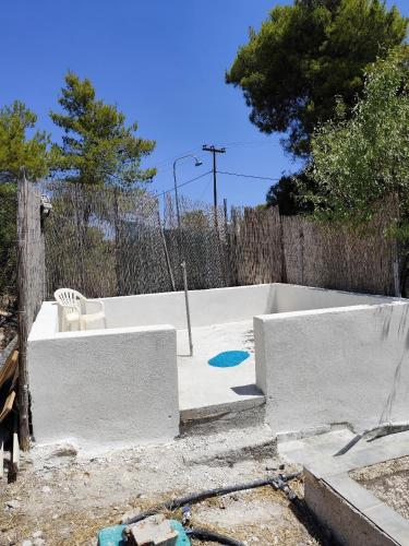 an unfinished backyard with a pool and a fence at σπίτι - αγρόκτημα - Δ Γεωργά Χατζηράση οδός Χατζηράση in Porto Heli