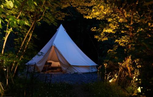 a white tent in the middle of a forest at Landscape Hotel THEATER 1 in Hinohara
