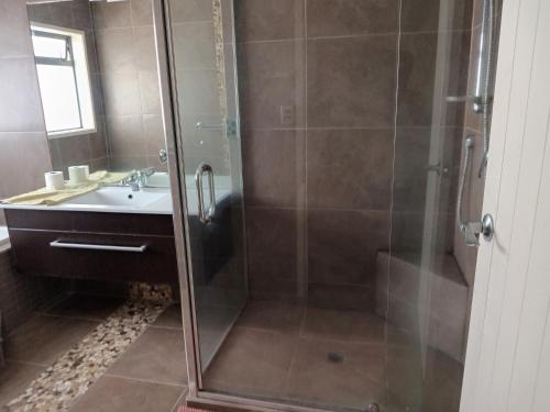 a bathroom with a shower and a sink at 10a monowai street, bayfair in Mount Maunganui