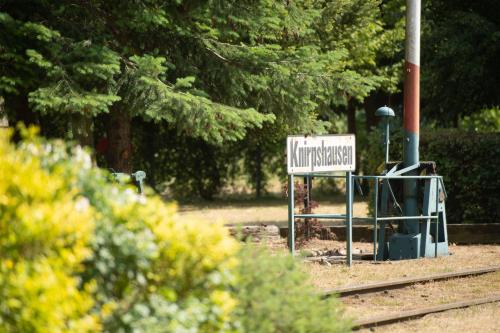 a sign on the tracks in front of a park at Lokschuppen Pasewalk- Gästehaus Lokschuppen in Pasewalk
