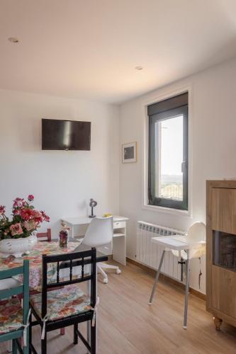 a living room with a table and a window at Apartamentos A Chousa in Valdoviño