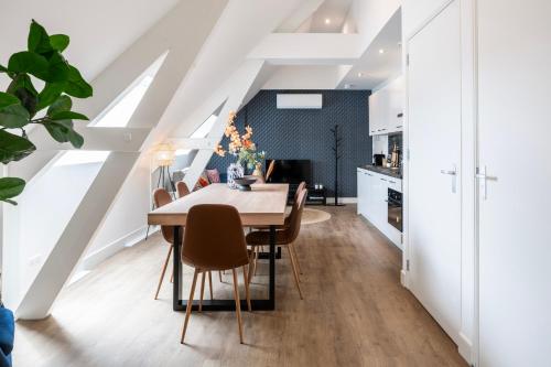 a kitchen and dining room with a table and chairs at XL home 2BR near university and supermarket in Tilburg
