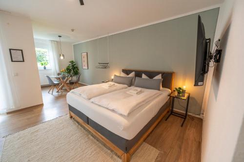 a bedroom with a large bed with a television on the wall at RR - Studio Apartment 38 qm - Parking - Washer in Magdeburg