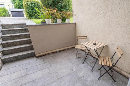 a patio with two chairs and a table and stairs at RR - Studio Apartment 38 qm - Parking - Washer in Magdeburg